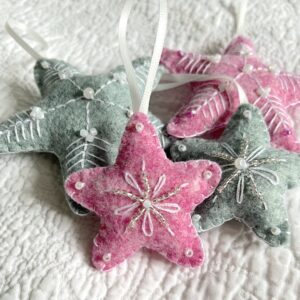 A handmade felt star hanging decoration. Small size. Handmade in felt and hand sewn and embellished with glass beads and a hanging ribbon. Approximate size 6cm x 6cm (not including hanging ribbon) This is a decoration only, and is NOT a toy. Keep out of the reach of babies and small children due to the small parts.
