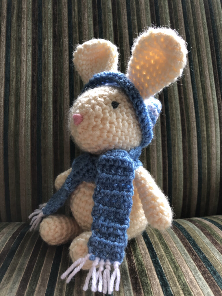 Hand crocheted bunny rabbit, with bobble hat and scarf.