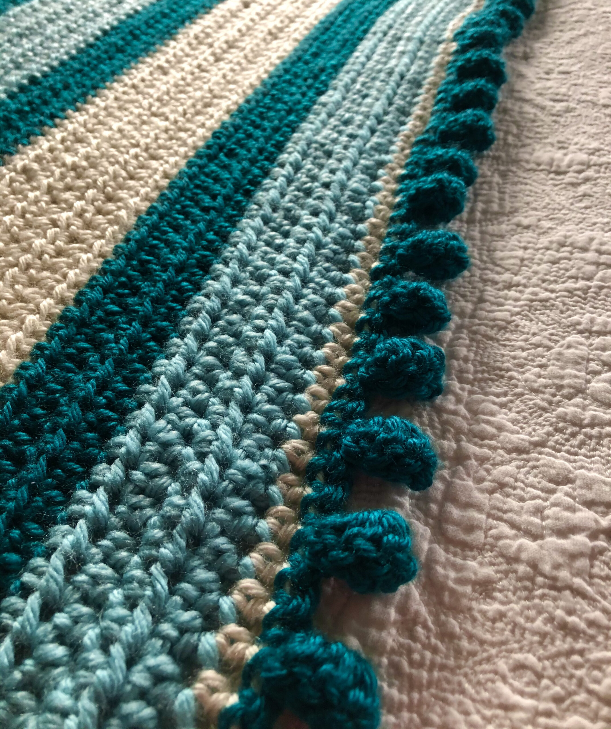 Teal striped blanket.