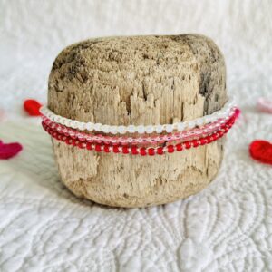 A handmade, crocheted and glass beaded bracelet. Fully adjustable with sliding glass bead fastening. 3 strands, made using 100% cream cotton and glass beads in 3 colours of Red, Pink and Pearlescent cream. No plastic! Eco-friendly, vegan friendly and completely recyclable.