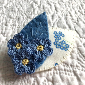 Posy of 3 Forget-Me-Not crocheted flowers and two leaf brooch. 100% Cotton flowers with hand stitched felt and fabric leaves.