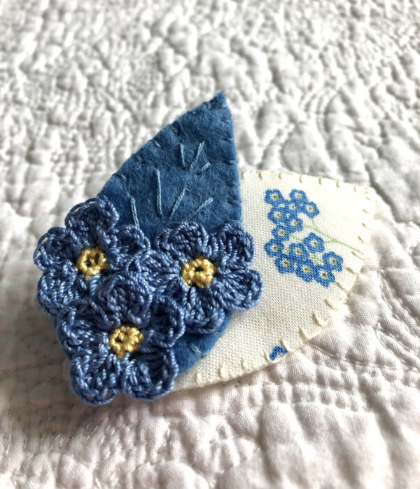 Posy of 3 Forget-Me-Not crocheted flowers and two leaf brooch. 100% Cotton flowers with hand stitched felt and fabric leaves.