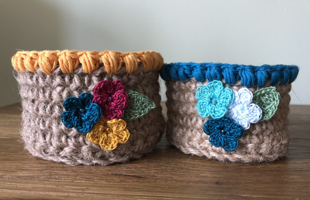 Handmade, crocheted 100% jute baskets. (Available in various sizes.) Decorated with 100% cotton crocheted flowers and leaves. 