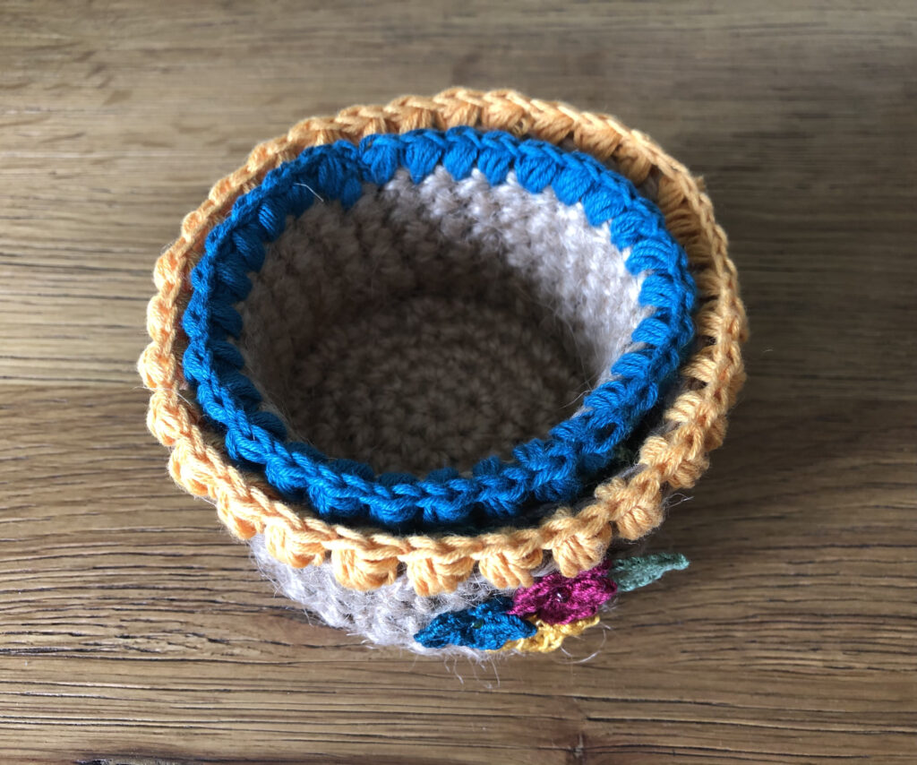 Handmade, crocheted 100% jute baskets. (Available in various sizes.) Decorated with 100% cotton crocheted flowers and leaves.