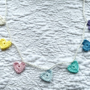 7 tiny crocheted hearts in a range of pastel colours. They are attached on a crocheted, natural cream cotton strand. Made in 100% cotton. Eco-friendly, vegan, recyclable, reusable. Total length approximately 53cm. Each heart measures approximately 2 x 2.5cm.