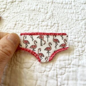 Handmade fabric and felt brooch with crocheted edging detail and a metal locking fastening. Approximate size 6cm Width x 4cm Height.
