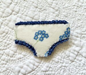 Handmade fabric and felt brooch with crocheted edging detail and a metal locking fastening. Approximate size 6cm Width x 4cm Height.