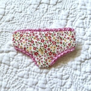 Handmade fabric and felt brooch with crocheted edging detail and a metal locking fastening. Approximate size 6cm Width x 4cm Height.