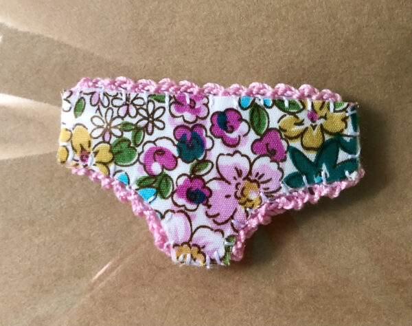 Handmade fabric and felt brooch with crocheted edging detail and a metal locking fastening. Approximate size 6cm Width x 4cm Height.