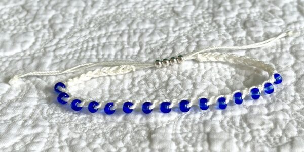 A handmade, crocheted, fully adjustable, single stranded bracelet. Made using glass beads and 100% cotton. No plastic!